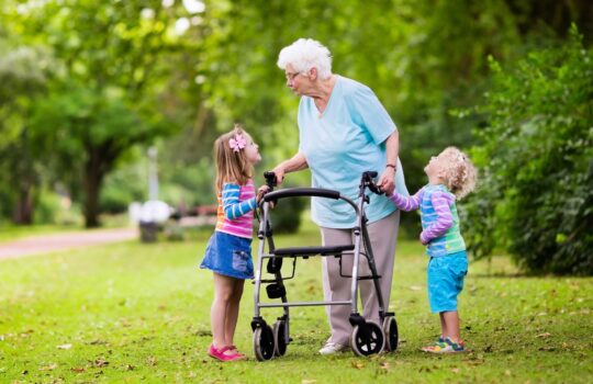Grandmother with walker playing with two kids
